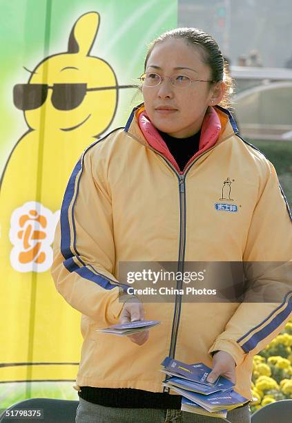 Volunteer worker hands out free condoms to passers-by during an event organized by the local government to promote AIDS prevention on November 28,...