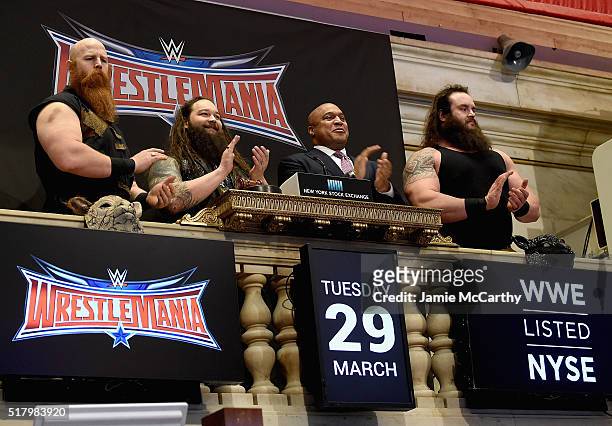 Superstars Erick Rowan, Bray Wyatt and Braun Strowman with NYSE Global head of capital markets Garvis Toler ring The New York Stock Exchange Opening...