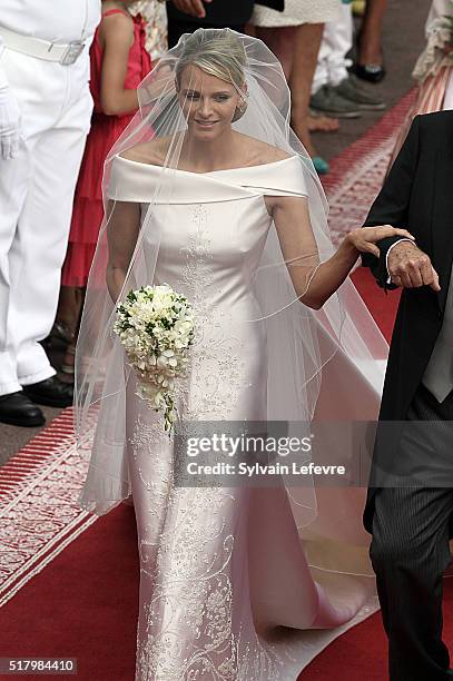 Princess Charlene , on her father Mike Wittstock's arm, walks along a red carpet from the Carabiniers Barracks to the altar for the wedding ceremony...