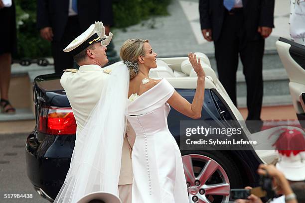 Prince Albert II of Monaco and Princess Charlene leave the Palace for the Sainte Devote Church after their wedding mass in the Main Courtyard of the...