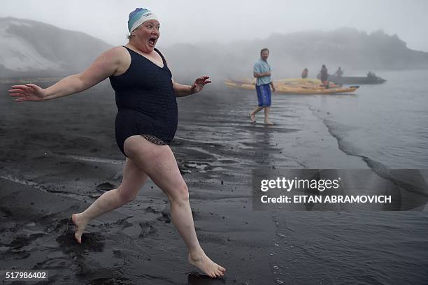 Tourist runs to jump into the hot springs of the crater lake of of Deception Island, Antarctica, on March 06, 2016. The Antarctic tourism industry is...