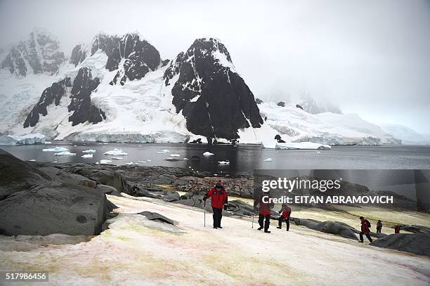 Tourists visit Pleneau Island, Antarctica, on March 03, 2016. The Antarctic tourism industry is generally considered to have begun in the late 1950s...