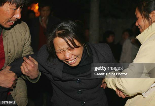 Chinese woman mourns the death of a loved one after a gas explosion tore through the state-owned Chenjiashan Coal Mine on November 28, 2004 in...