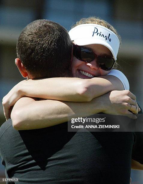 British model Josie Kidd hugs Scottish golfer Andrew Coltart on the 18th hole at the Nelson Mandela Invitational Golf Tournament at Arabella Golf...