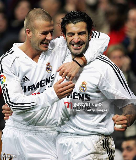 Real Madrid?s Luis Figo celebrates with teammate David Beckham after he scored a goal against Levante during their la Liga match at the Bernabeu,...
