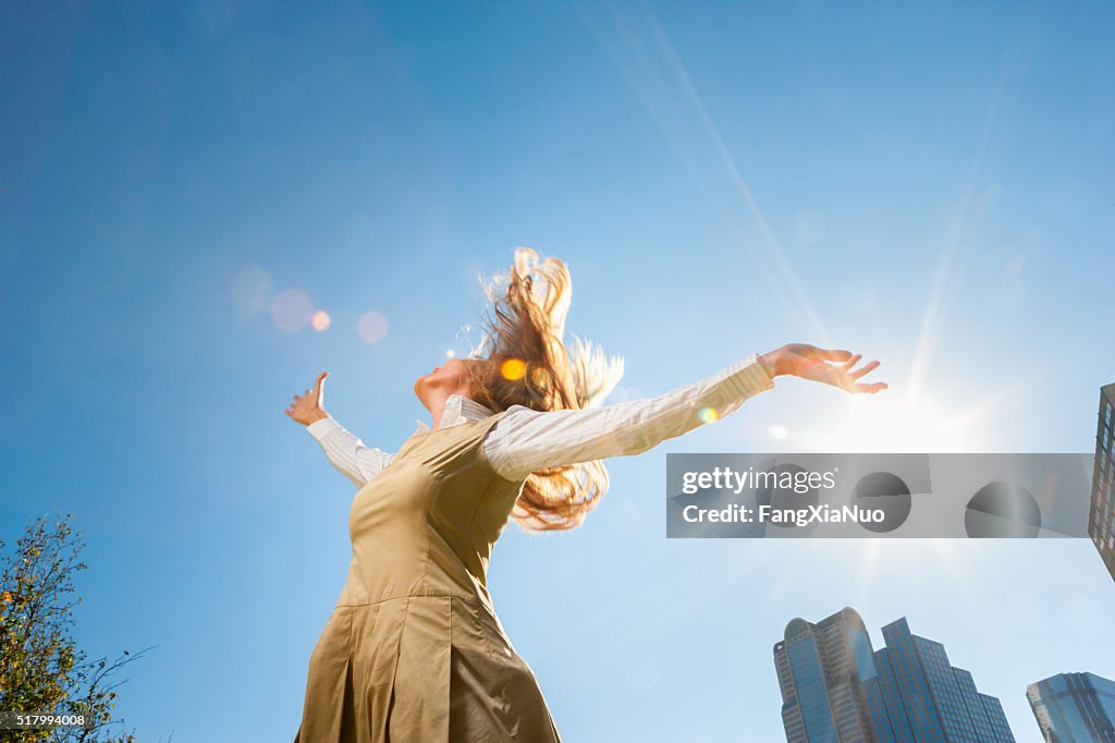 Girl spinning outside in sunshine