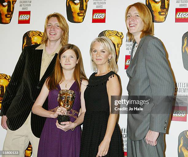 Oliver Phelps, Bonny Wright, Lisa Maxwell and James Phelps pose at the boards during the "British Academy Children's Film and Television Awards" on...