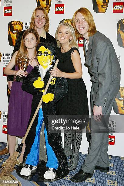 Oliver Phelps, Bonny Wright, Lisa Maxwell and James Phelps pose with a Harry Potter Lego Model at the boards during the "British Academy Children's...