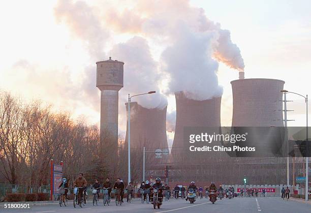 Workers leave after a day's work at a steel mill of the Baotou Iron and Steel Group on November 26, 2004 in Baotou, China. The group is one of the...