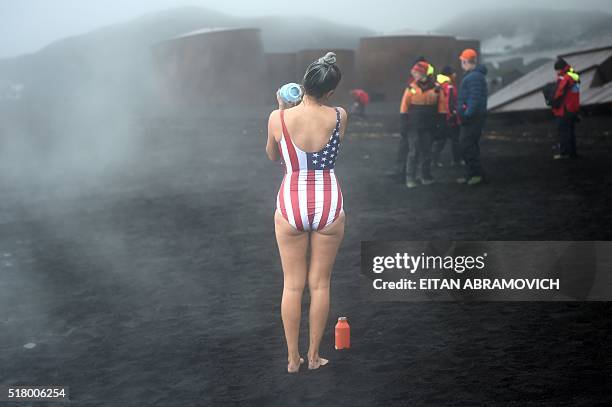 Tourists enjoy the hot springs of the crater lake of Deception Island, Antarctica, on March 06, 2016. The Antarctic tourism industry is generally...