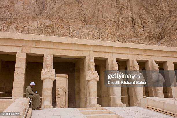 Portrait of a local guide near the colossi of Pharaohs at the otherwise deserted ancient Egyptian Temple of Hatshepsut near the Valley of the Kings,...