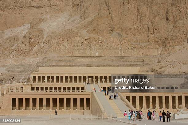 Few tourists approach the ancient Egyptian Temple of Hatshepsut near the Valley of the Kings, Luxor, Nile Valley, Egypt. The Mortuary Temple of Queen...