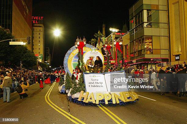County Sheriff Lee Baca and actress Sofia Milos ride on The Way to Happiness Foundation float at the 73rd Annual Hollywood Christmas Parade on...