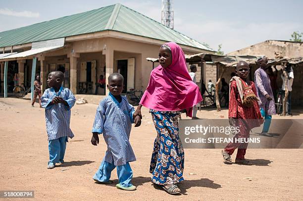 Children walk down the street of Chibok in Borno State northeast Nigeria on March 25, 2016. On April 14 Boko Haram militants kidnapped 276...