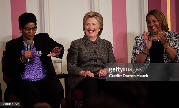 Democratic presidential candidate Hillary Clinton and Annette Holt listen to Geneva Reed-Veal talks to the crowd at a Community Forum on Gun Violence...