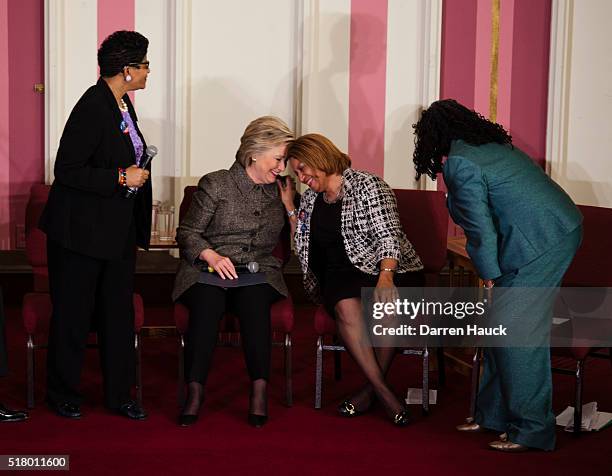 Geneva Reed-Veal looks on as Democratic presidential candidate Hillary Clinton and Annette Holt greet each other at a Community Forum on Gun Violence...