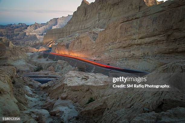 vehicle passing through highway - balochistan stock pictures, royalty-free photos & images