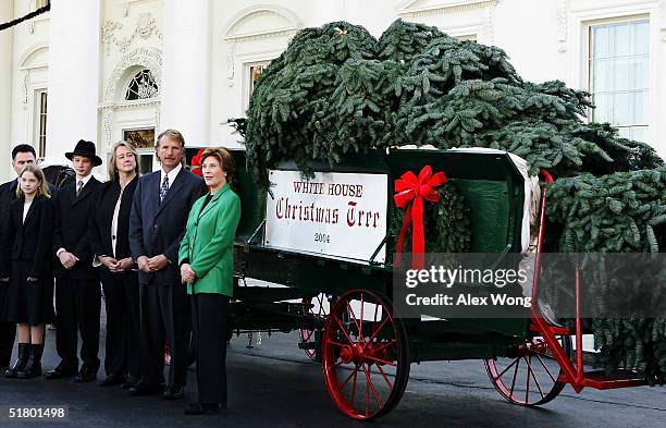 First Lady Laura Bush speaks to the media as she receives the official White House Christmas tree, an 18 1/2 foot Noble fir, from John Tillman, Carol...