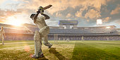 Cricket Batsman Hitting Ball During Cricket Match In Stadium