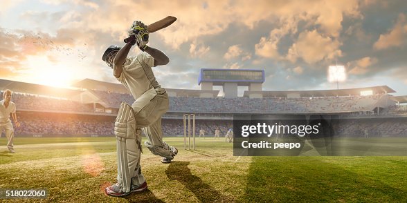 Cricket Batsman Hitting Ball During Cricket Match In Stadium Cricket Batsman Hitting Ball During Cricket Match In Stadium
