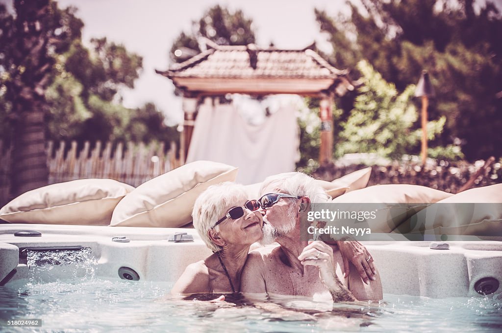 Cheerful Senior Couple Enjoying Summer Vaccation in hot tub
