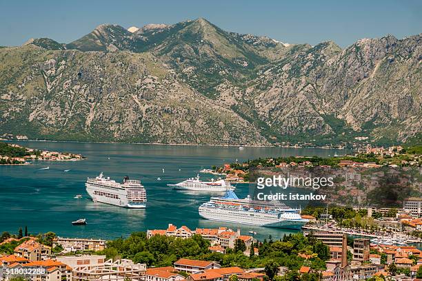 three cruise liners in front of kotor port, - departure board front on stockfoto's en -beelden