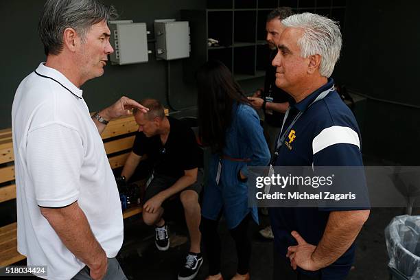 Executive Vice President of Baseball Operations Billy Beane of the Oakland Athletics talks with ESPN's Pedro Gomez in the clubhouse prior to a spring...