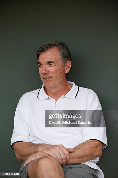 Executive Vice President of Baseball Operations Billy Beane of the Oakland Athletics relaxes in the dugout prior to a spring training game against...