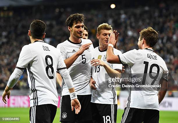 Mats Hummels of Germany and Toni Kroos of Germany congratulate Mario Goetze after he scored the second goal during the International Friendly match...