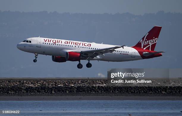 Virgin America plane lands at San Francisco International Airport on March 29, 2016 in Burlingame, California. JetBlue Airways and Alaska Air Group...