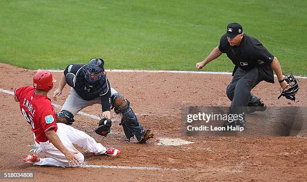 Brian McCann of the New York Yankees tags out Will Venable of the Philadelphia Phillies at home plate during the third inning of the Spring Training...