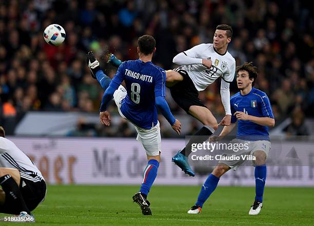 Thiago Motta of Italy and Julian Draxler of Germany compete for the ball during the international friendly match between Germany and Italy at Allianz...