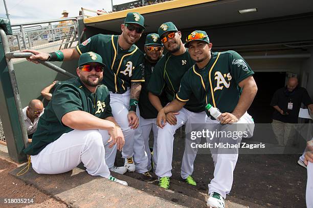 Yonder Alonso, Rangel Ravelo, Angel Castro, Felix Doubront and Franklin Barreto of the Oakland Athletics relax in the dugout during a spring training...