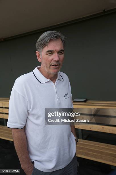 Executive Vice President of Baseball Operations Billy Beane of the Oakland Athletics stands in the dugout prior to a spring training game against the...