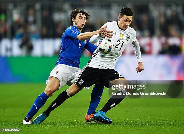 Julian Draxler of Germany is challenged by Matteo Darmian of Italy during the International Friendly match between Germany and Italy at Allianz Arena...