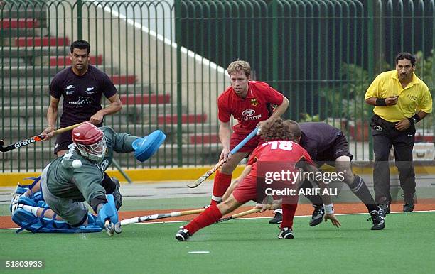 German field hockey goalkeeper Max Weinhold trys to save a goal against New Zealand during a practice match at the National Hockey Stadium in Lahore,...