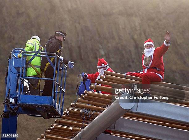 Two men dressed as Santas scale the new Scottish Parliament building, Holyrood, on November 30, 2004 in Edinburgh, Scotland. The two men performed...