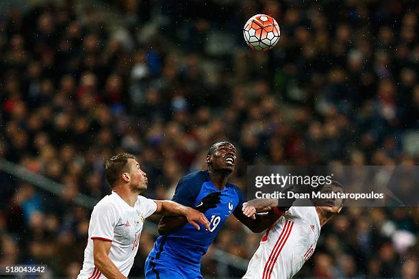 Paul Pogba of France battles for the ball with Vasily Berezutski and Alan Dzagoev of Russia during the International Friendly match between France...