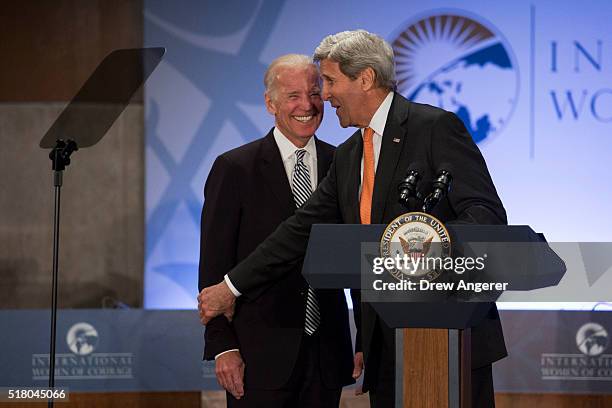 Vice President Joe Biden laughs as Secretary of State John Kerry introduces him to speak at the 2016 International Women of Courage Forum at the...