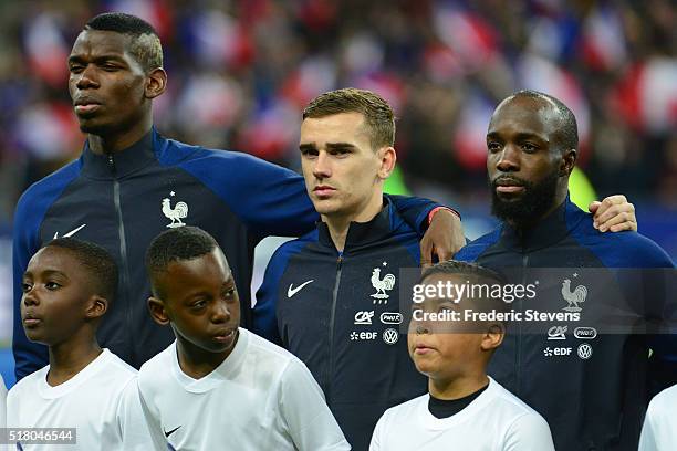 The France players Paul Pogba , Antoine Grietzmann and Lassana Diarra pose during the national hyme before the International Friendly match between...