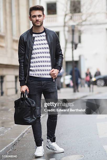 Kevin Ragonneau is wearing a Zara black leather jacket, Zara black jeans, a Brice black bag, a Kapten watch, a Pull and Bear striped top, and Baron...