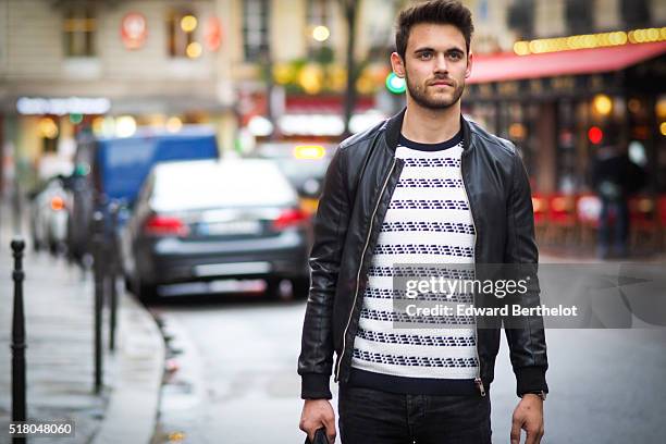 Kevin Ragonneau is wearing a Zara black leather jacket, Zara black jeans, a Brice black bag, a Kapten watch, a Pull and Bear striped top, and Baron...