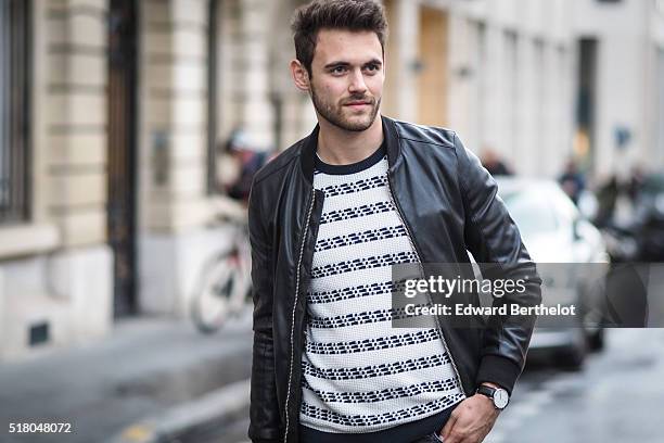 Kevin Ragonneau is wearing a Zara black leather jacket, Zara black jeans, a Brice black bag, a Kapten watch, a Pull and Bear striped top, and Baron...