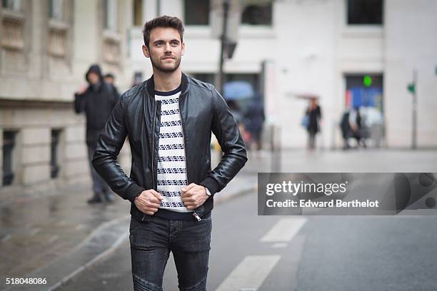 Kevin Ragonneau is wearing a Zara black leather jacket, Zara black jeans, a Brice black bag, a Kapten watch, a Pull and Bear striped top, and Baron...