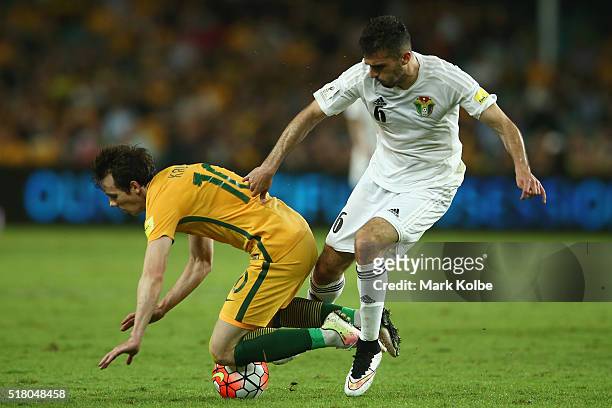 Robbie Kruse of Australia is tackled by Ehsan Haddad of Jordan during the 2018 FIFA World Cup Qualification match between the Australian Socceroos...