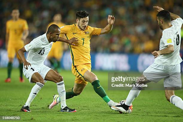 Mathew Leckie of Australia contests the ball with Yaseen Al-Bakhit and Ehsan Haddad of Jordan during the 2018 FIFA World Cup Qualification match...