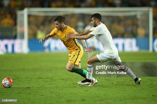 Mathew Leckie of Australia takes the ball passed the defender during the 2018 FIFA World Cup Qualification match between the Australian Socceroos and...