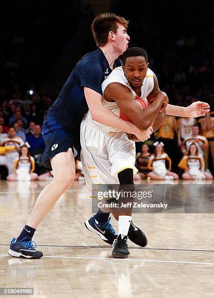 Zac Seljaas of the Brigham Young Cougars fights for the ball with Keith Carter of the Valparaiso Crusaders during their NIT Championship Semifinal...