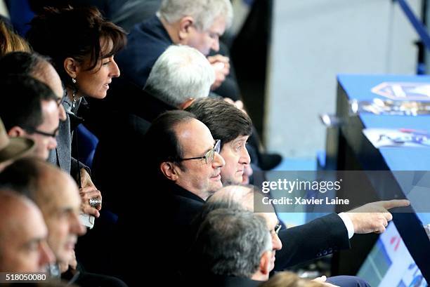 Nathalie Iannetta and President Francois Hollande react during the International Friendly games between France and Russia at Stade de France on March...