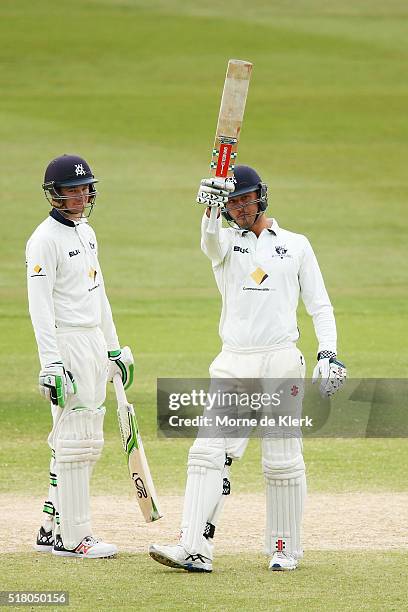 Marcus Stoinis of the VIC Bushrangers celebrates reaching 50 runs as teammate Peter Handscomb looks on during day 5 of the Sheffield Shield Final...